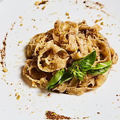 Image showing Tagliatelle with mushrooms and decorated with basil leaves.