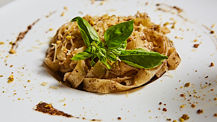 Image showing Tagliatelle with mushrooms and decorated with basil leaves.