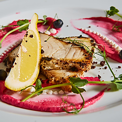 Image showing White fish with lemon on white plate, selective focus