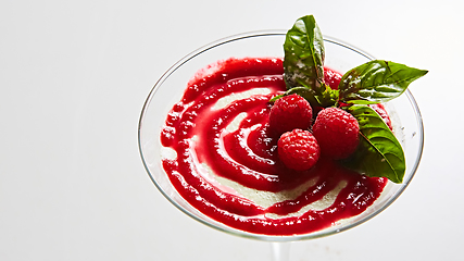 Image showing Delicious Italian dessert Panna Cotta with raspberry in small transparent glass