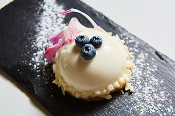 Image showing Vanilla bavarian mousse cake with cherries and dark chocolate on top. Made with cream cheese and whipped cream