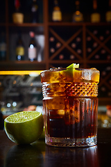 Image showing High angle view of a glass of Cuba Libre cocktail with rum, coke, lemon juice and ice cubes