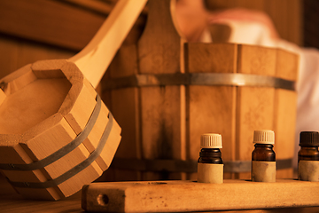 Image showing Wooden bath accessories with aromatic oil bottle for bath