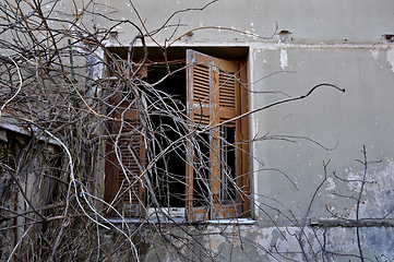 Image showing peeling wall and broken window shutter