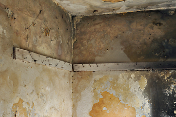 Image showing planks with rusty nails in abandoned interior