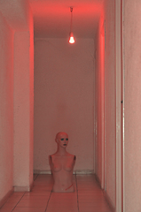 Image showing broken doll under red light