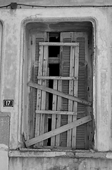 Image showing window shutter sealed with planks