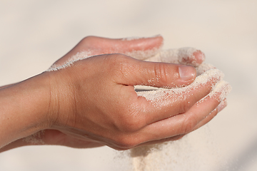 Image showing Sand running through hands