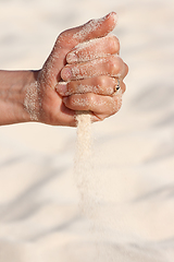 Image showing Sand running through hands