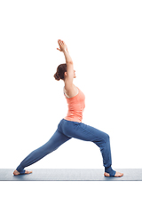 Image showing Woman practices yoga asana utthita Virabhadrasana