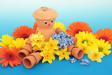 Image showing Flowerpot Man Garden Ornament Bathed in Flowers 