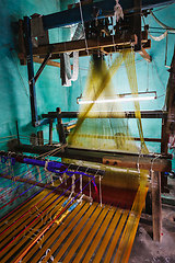 Image showing Man weaving silk sari on loom in India