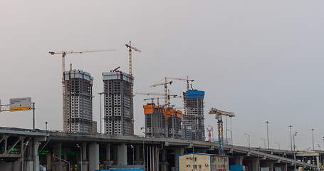Image showing Many of cranes. Tower cranes against blue sky, with clouds