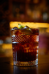Image showing High angle view of a glass of Cuba Libre cocktail with rum, coke, lemon juice and ice cubes