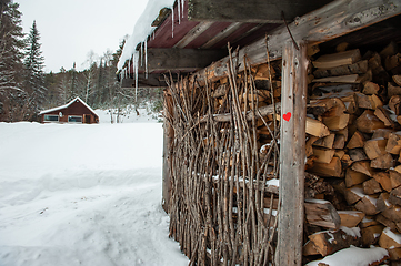 Image showing Stack of natural wood, with red heart