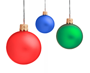 Image showing Several hanging Christmas baubles isolated