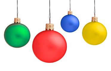 Image showing Several hanging Christmas baubles isolated