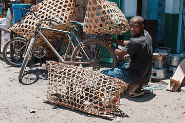 Image showing Seller man preparing the chickens to be sold, Madagascar