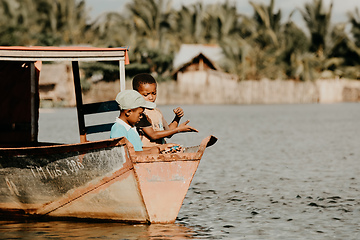 Image showing Young boys catch fish with fishing line