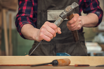 Image showing The worker makes measurements of a wooden board