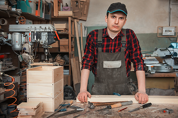 Image showing Carpenter working with a chisel