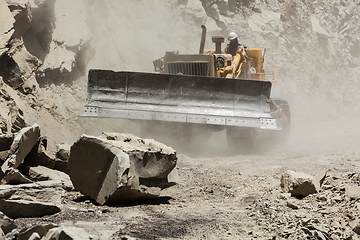 Image showing Bulldozer cleaning landslide on road in Himalayas