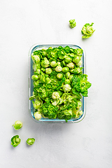 Image showing Fresh  organic green brussel sprouts and small winter cabbage vegetable in glass container, ready to freeze