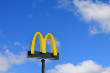 Image showing McDonald's Logo Against Blue Sky and White Clouds