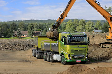 Image showing Excavator Loading Soil onto Volvo FH16 Truck Trailer