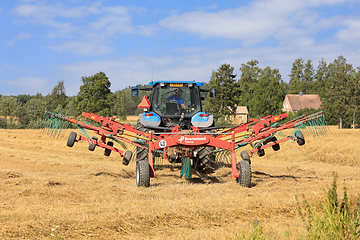 Image showing Tractor and Twin Rotary Rake Working in Field 