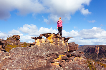 Image showing Female hiker high on a mountain pagoda looking at view