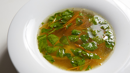 Image showing Hot broth with ravioli and green onions. Studio Photo.