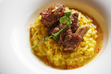 Image showing The ossobuco and saffron risotto. Shallow dof