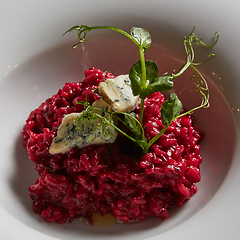 Image showing Beetroot risotto with blue cheese on a white plate.