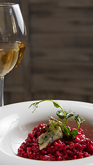 Image showing Beetroot risotto with blue cheese on a white plate.