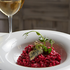 Image showing Beetroot risotto with blue cheese on a white plate.
