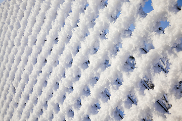 Image showing metal fence with snow