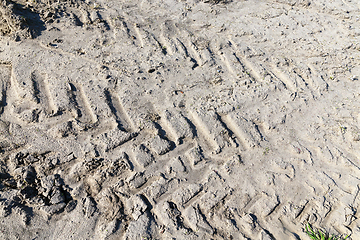 Image showing traces of the truck - the traces of heavy trucks on the ground agricultural fields. Photo closeup