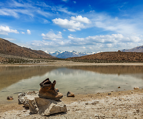 Image showing Trekking hiking boots at mountain lake in Himalayas