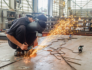 Image showing Industrial worker using angle grinder