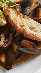 Image showing Seafood. Mussels in wine with croutons and lemon. Clams in the shells.