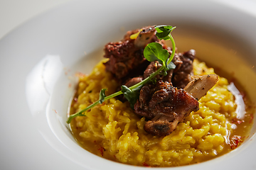 Image showing The ossobuco and saffron risotto. Shallow dof