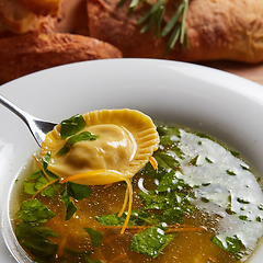 Image showing Hot broth with ravioli and green onions. Studio Photo.