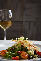 Image showing Fresh caesar salad on white bowl with parmesan cheese and shrimp