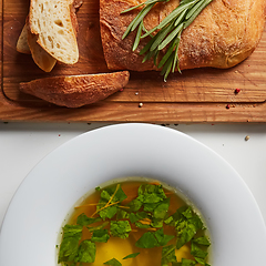 Image showing Hot broth with ravioli and green onions. Studio Photo.