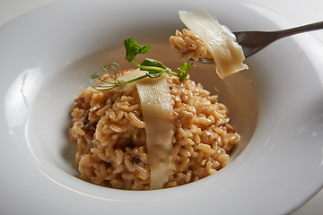 Image showing Italian dish risotto with wild white mushrooms and Parmesan chee