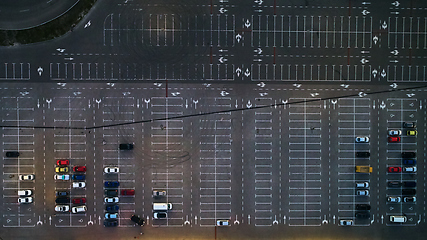 Image showing Aerial top view of parking lot with many cars from above, transportation and urban concept.