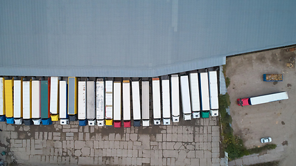 Image showing Aerial view of goods warehouse. Logistics center in industrial city zone from above.