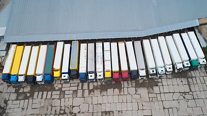 Image showing Aerial view of goods warehouse. Logistics center in industrial city zone from above.