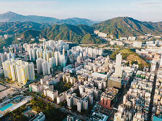 Image showing Aerial city view with crossroads and roads, houses, buildings an